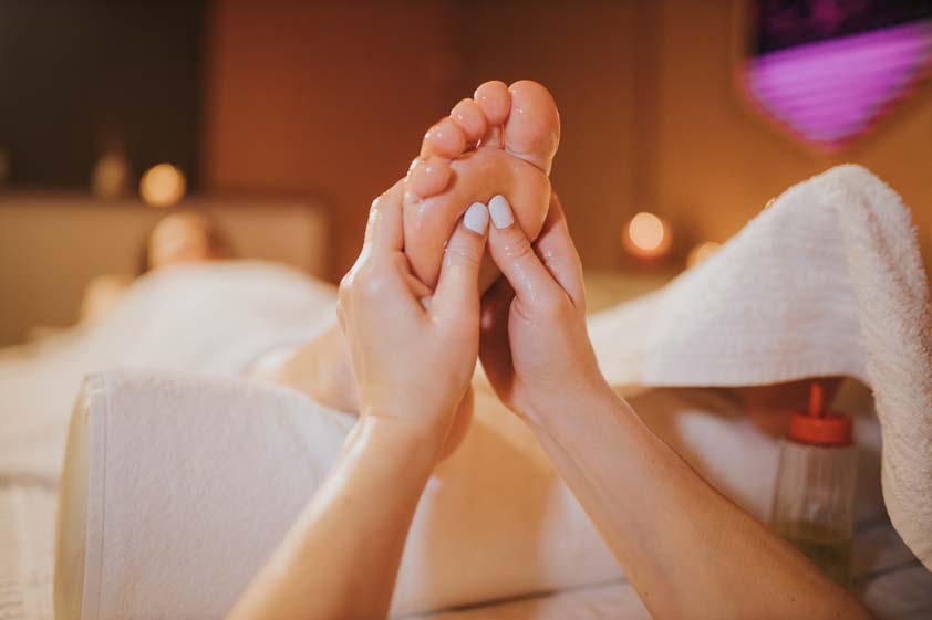 Woman getting a relaxing foot massage treatment in the spa salon